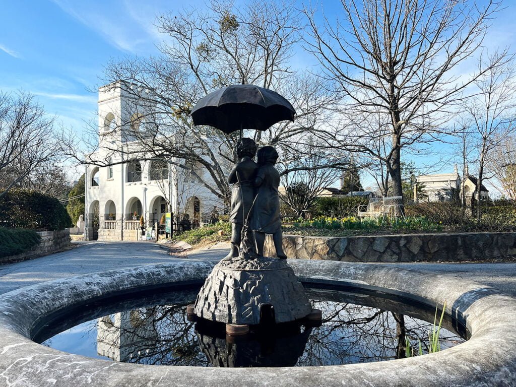 “Out in the Rain” statue and fountain with the Oakland Bell Tower in the background | atlantaandbeyond.com