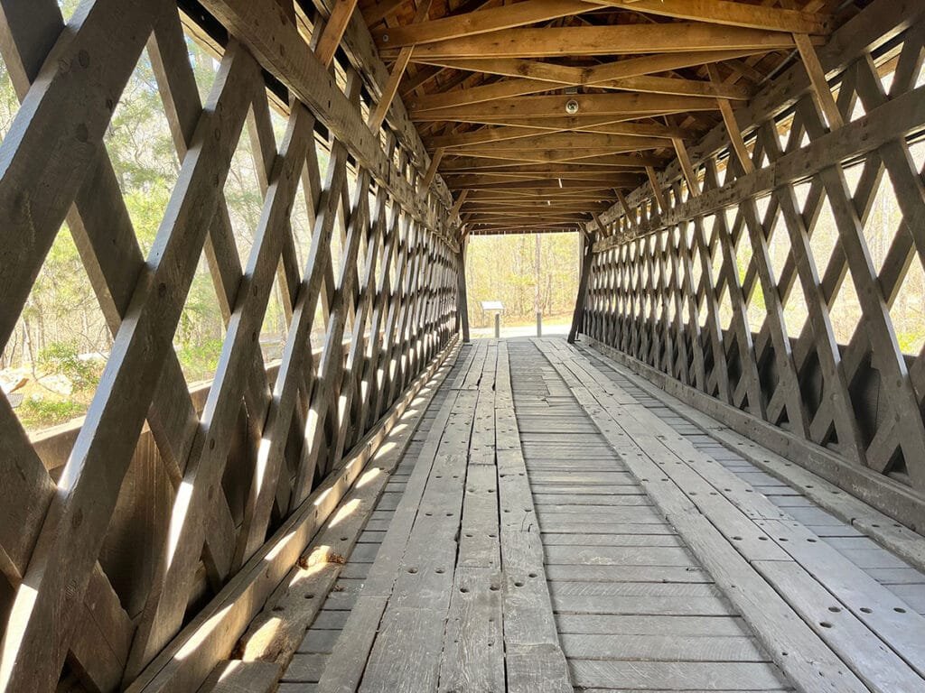 Historic Poole's Mill Covered Bridge built in the lattice truss style spans Settendown Creek in Forsyth County, Georgia | atlantaandbeyond.com