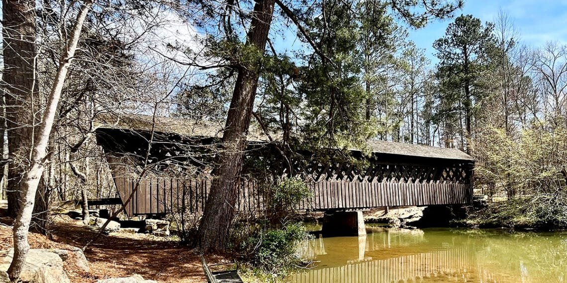 Historic Poole's Mill Covered Bridge built in the lattice truss style spans Settendown Creek in Forsyth County, Georgia | atlantaandbeyond.com