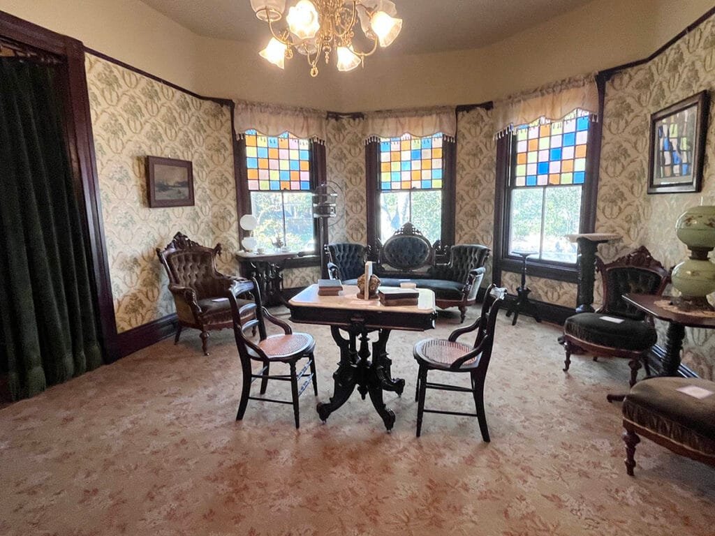 Note extra stained glass from nearby St. Anthony of Padua Catholic Church in the parlor at the Wren's Nest | atlantaandbeyond.com