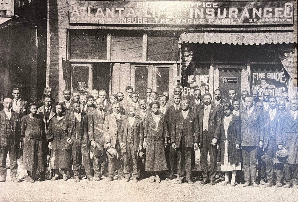 Employees standing outside the Atlanta Life Insurance Company on display in the basement of the Herndon Home in Atlanta | atlantaandbeyond.com